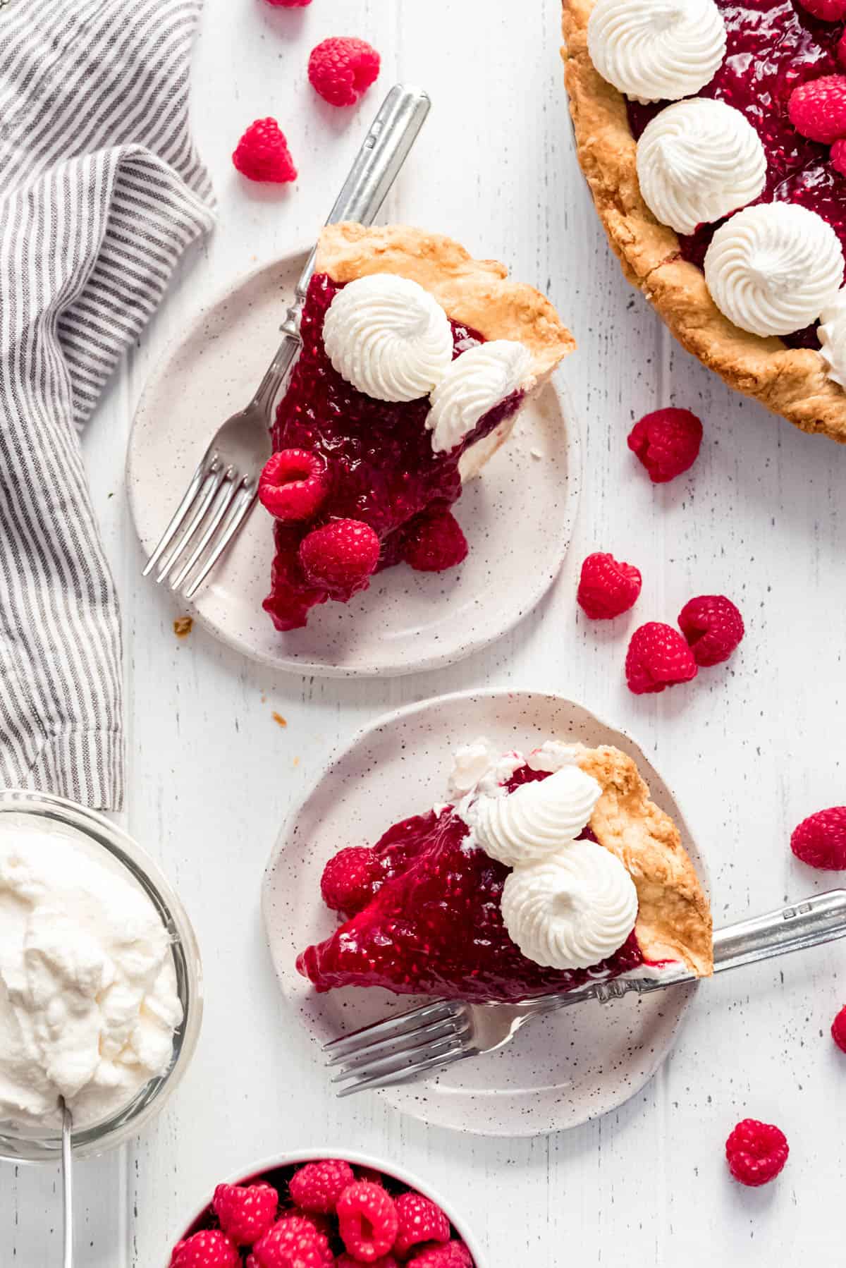 slices of raspberry cheesecake pie on plates with forks