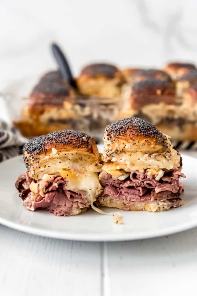 two roast beef sliders on a white plate