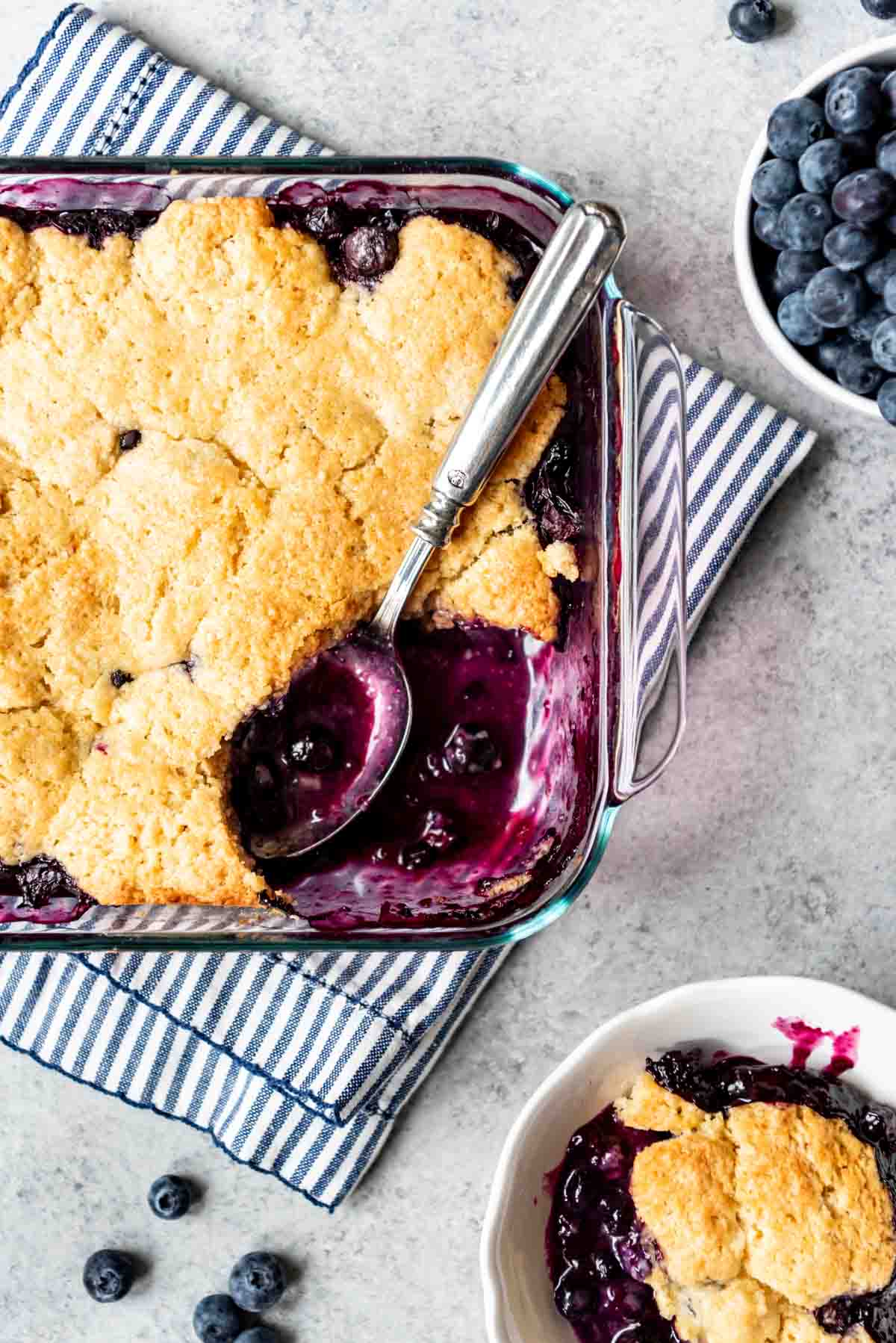 Old-fashioned blueberry cobbler is served into a small bowl. 