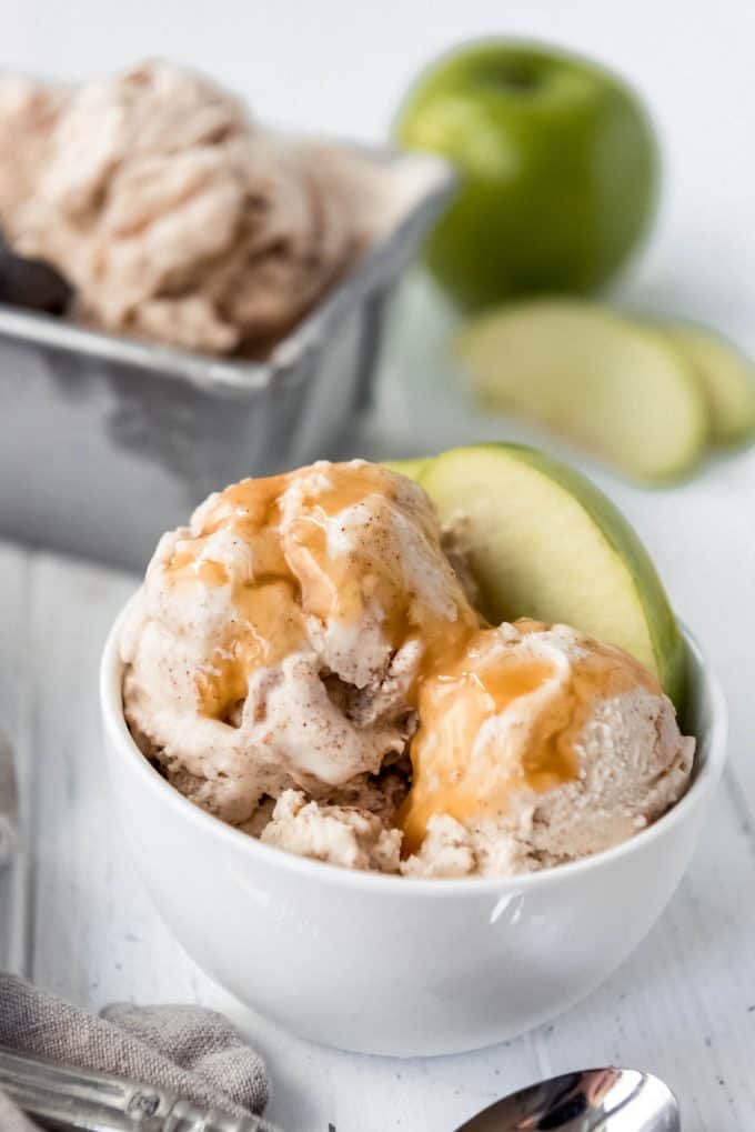 a bowl of apple pie ice cream with caramel sauce on top