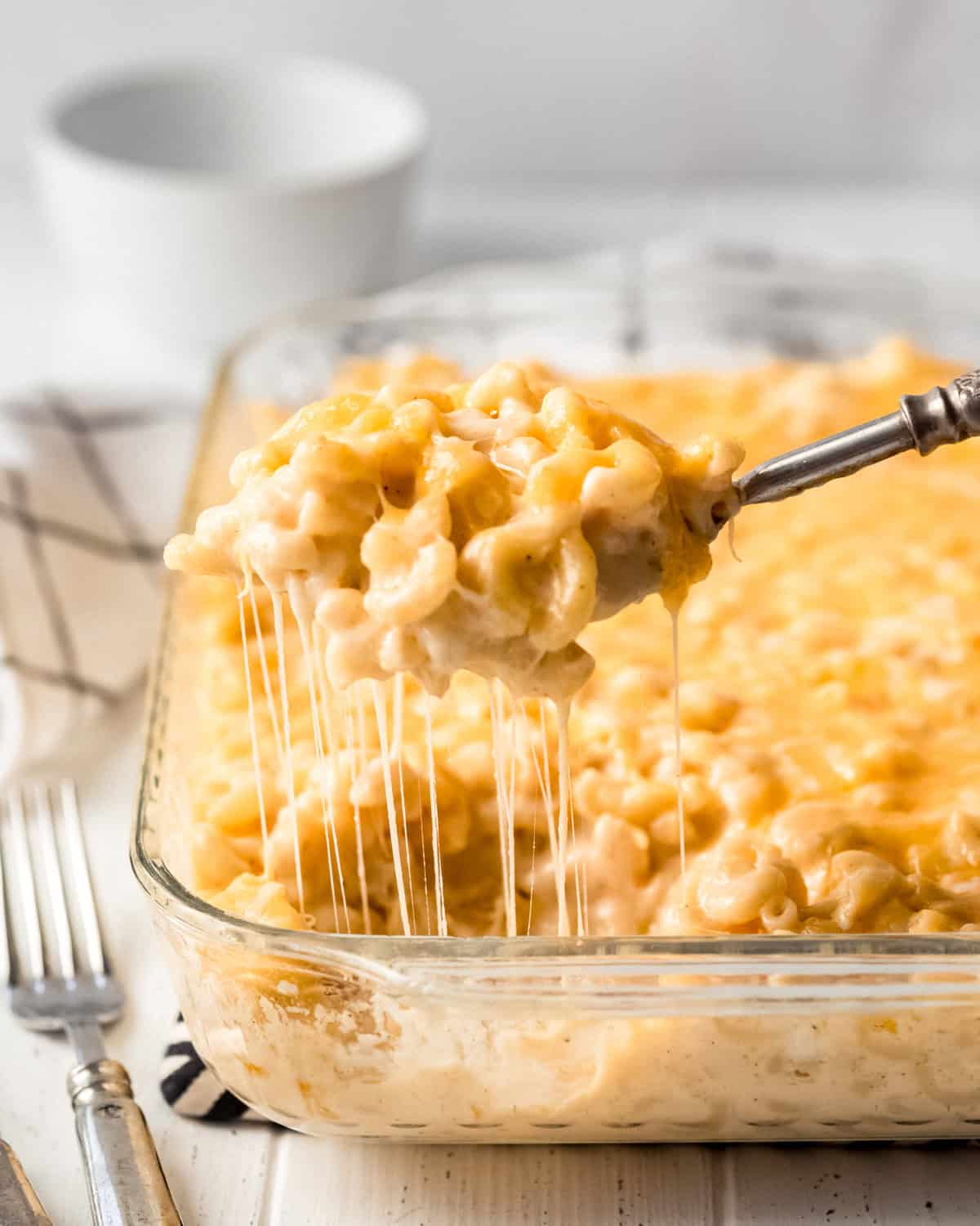 stretchy cheese hanging off a scoop of homemade mac and cheese