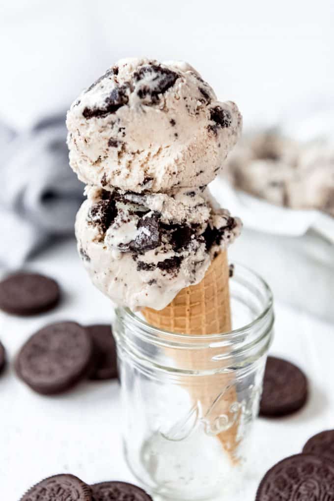 ice cream cone with two scoops of Cookies and cream ice cream inside of a mason jar.