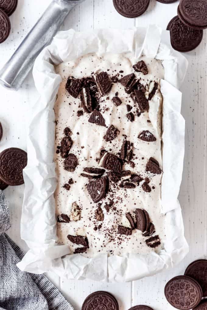Cookies and cream ice cream in a freezer safe container on a white table
