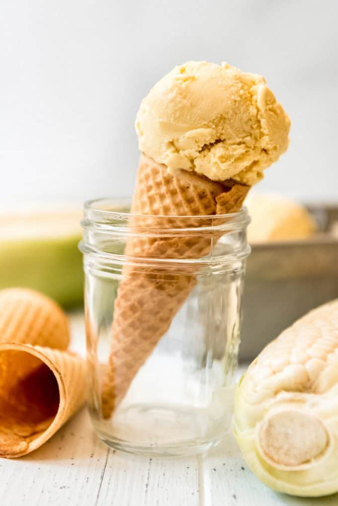 a scoop of corn ice cream on a sugar cone