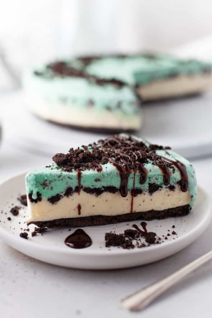 a slice of mint chip ice cream pie drizzled with chocolate sauce