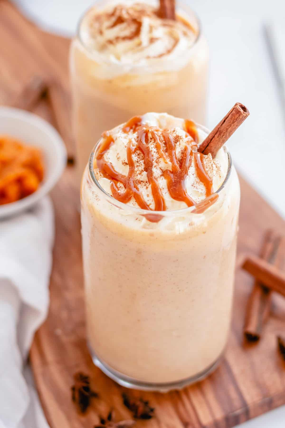Pumpkin Pie smoothie in a glass with caramel drizzle