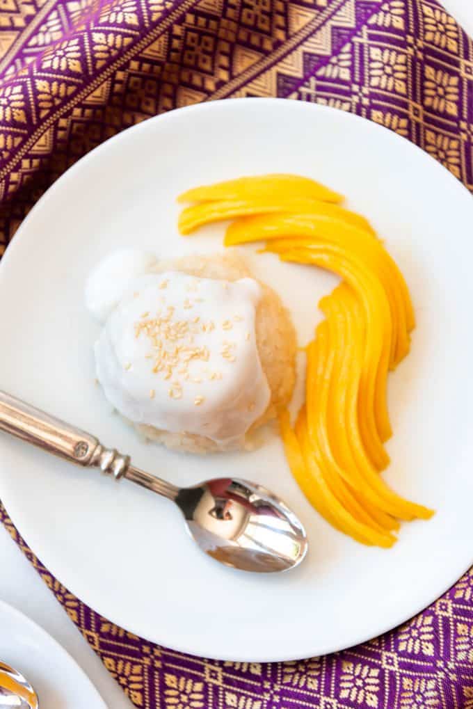 Top view of mango sticky rice on a white plate.