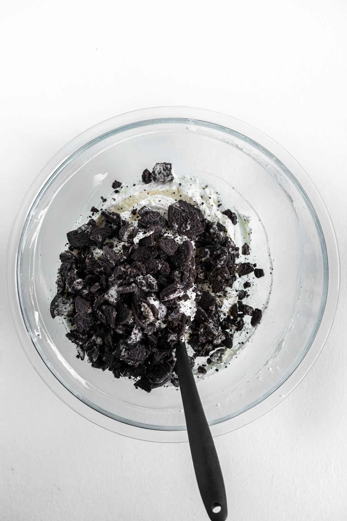 Crushed Oreos are placed on top of the cream cheese dip mixture. 