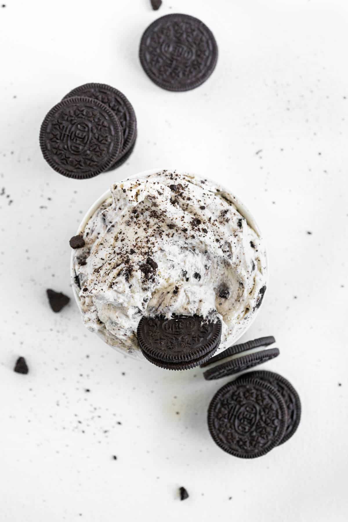 Overhead view of Oreo dip, with whole Oreos placed in the dip, as well as scattered around the edges. 