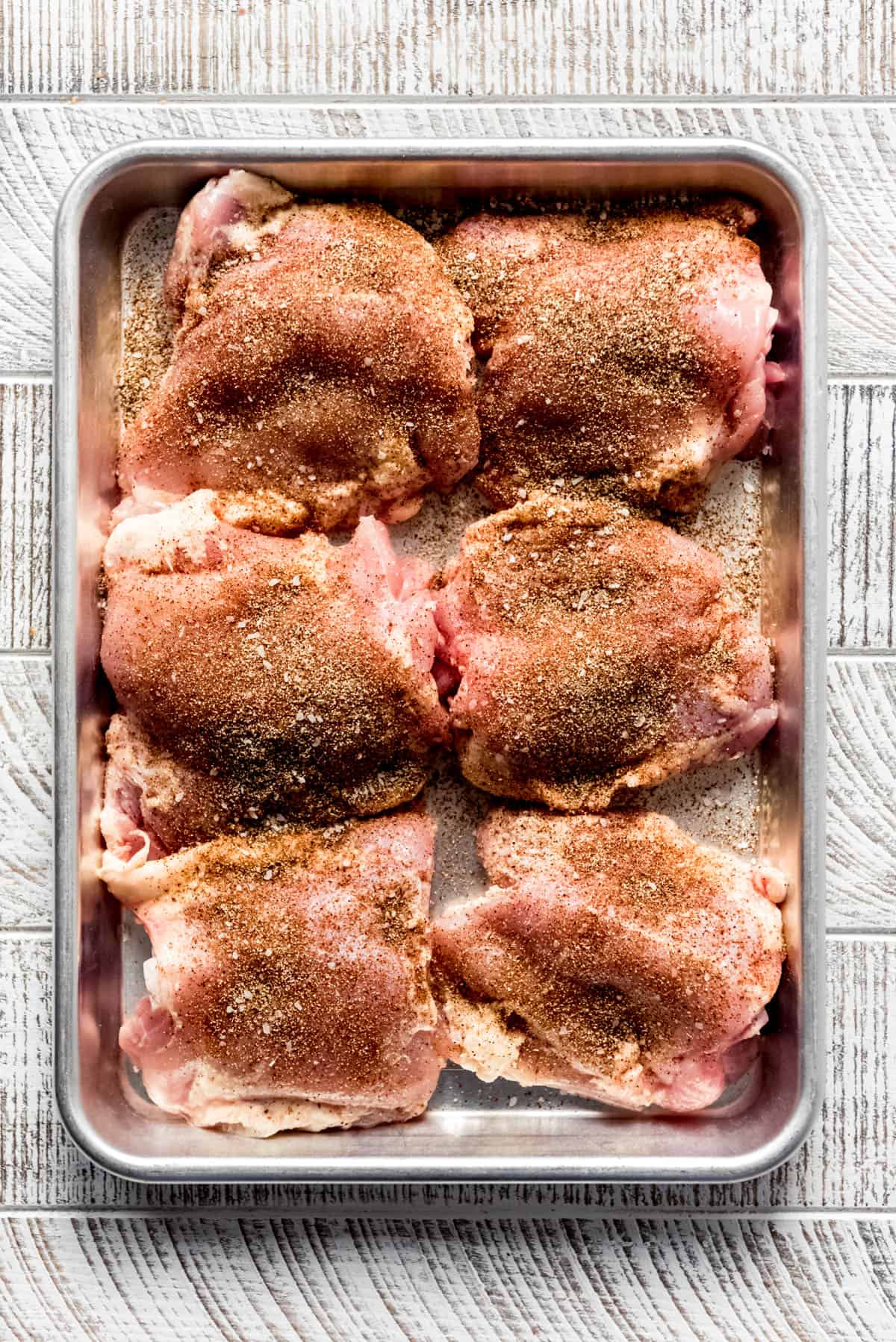 Chicken has been seasoned and prepared to be grilled. 