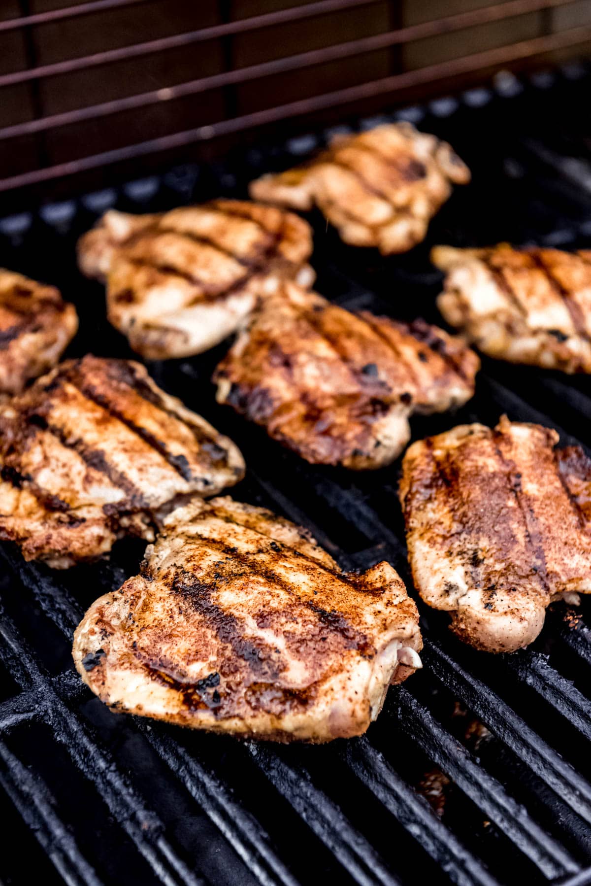 Chicken on a bbq grill, in the process of being cooked. 