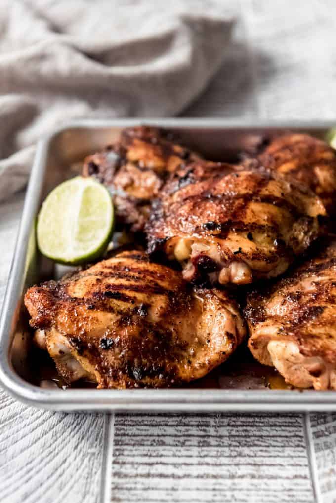 grilled chicken brushed with honey glaze on a baking sheet