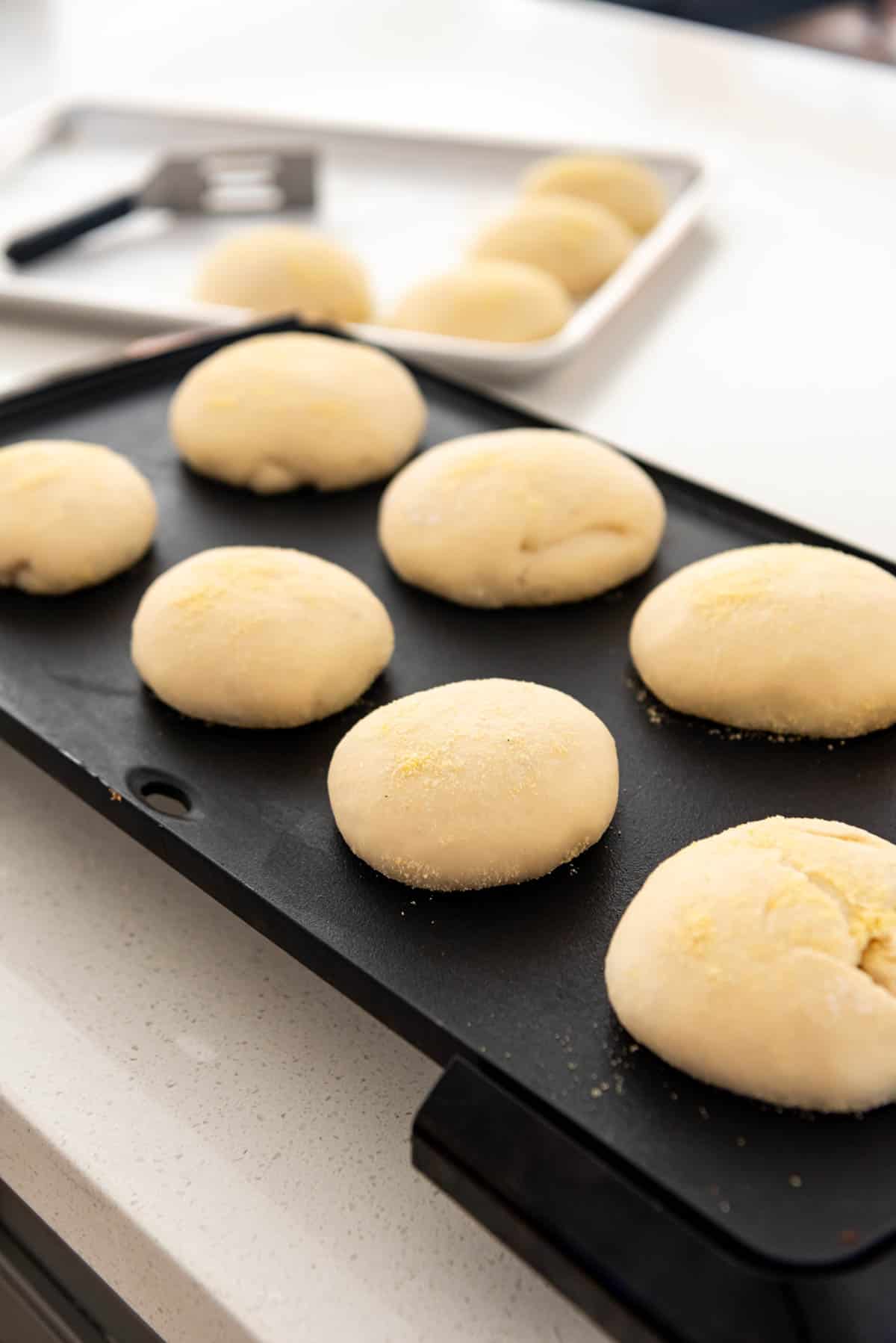 Cooking English muffins on a griddle.