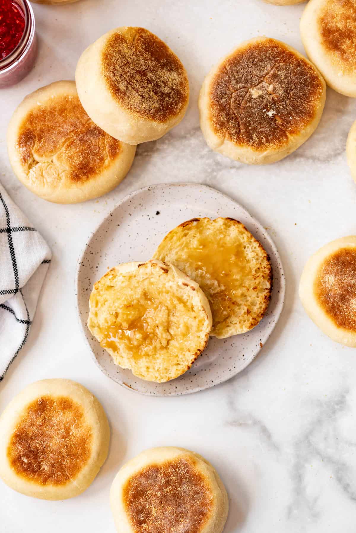 Homemade English Muffin sliced with honey on a plate