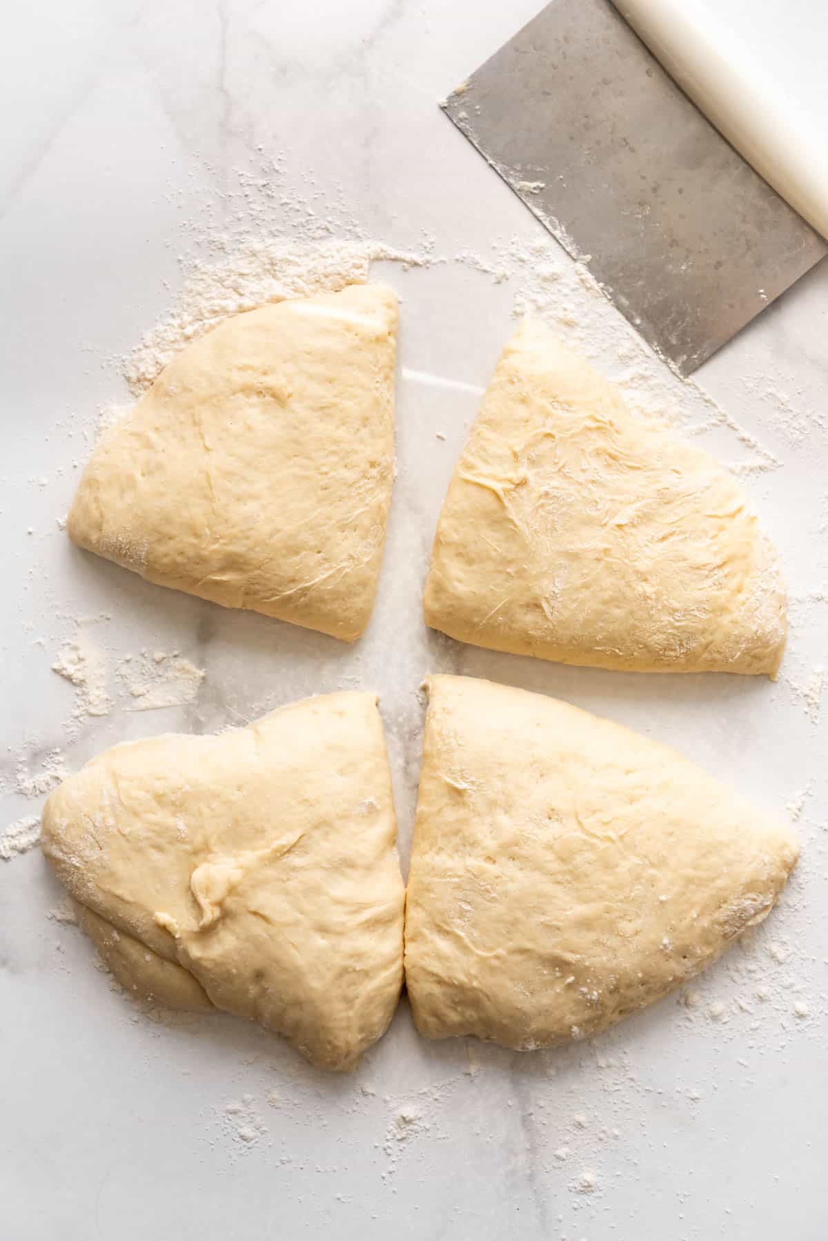 Dividing dough to make english muffins.