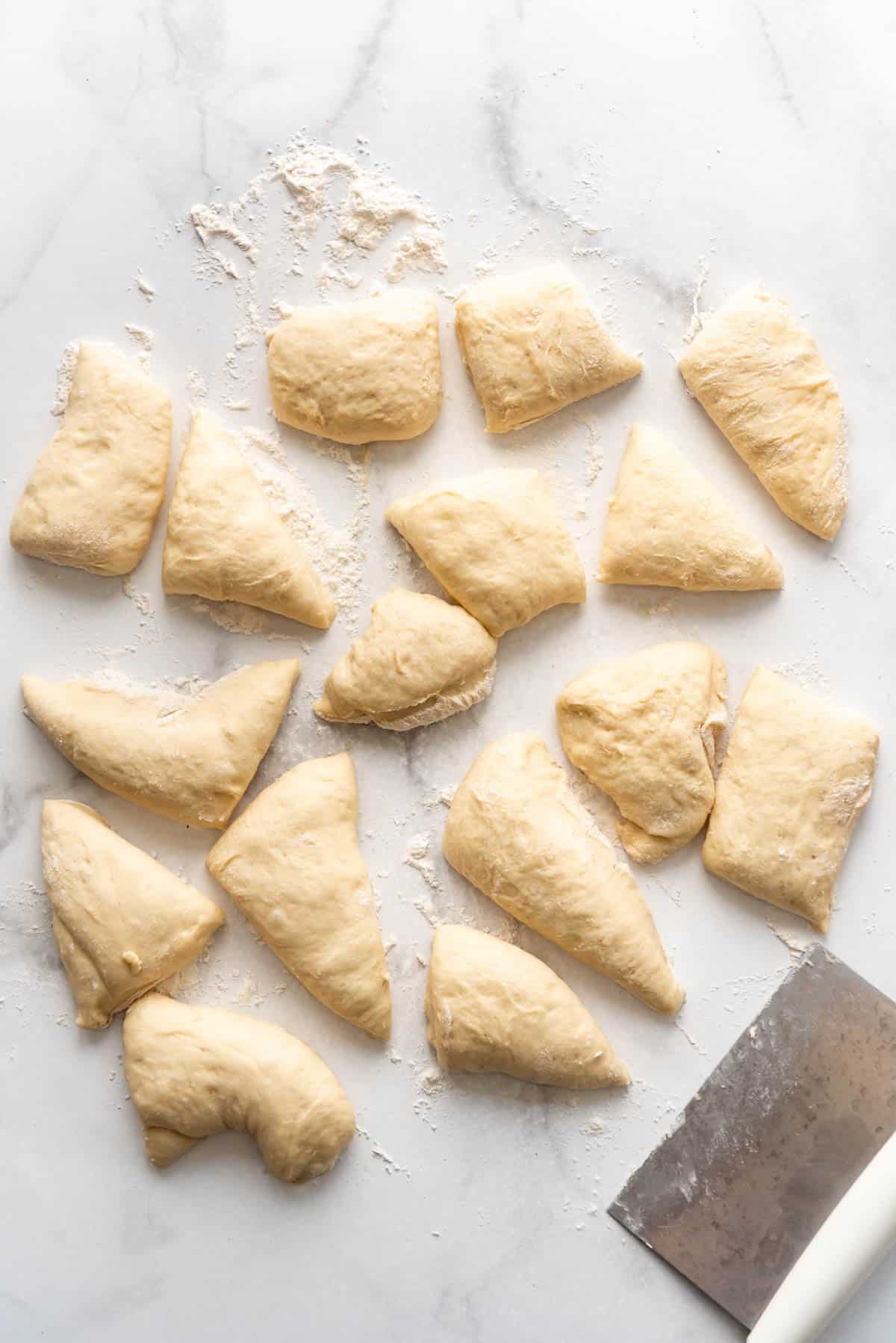 English muffin dough that has been cut into individual chunks.