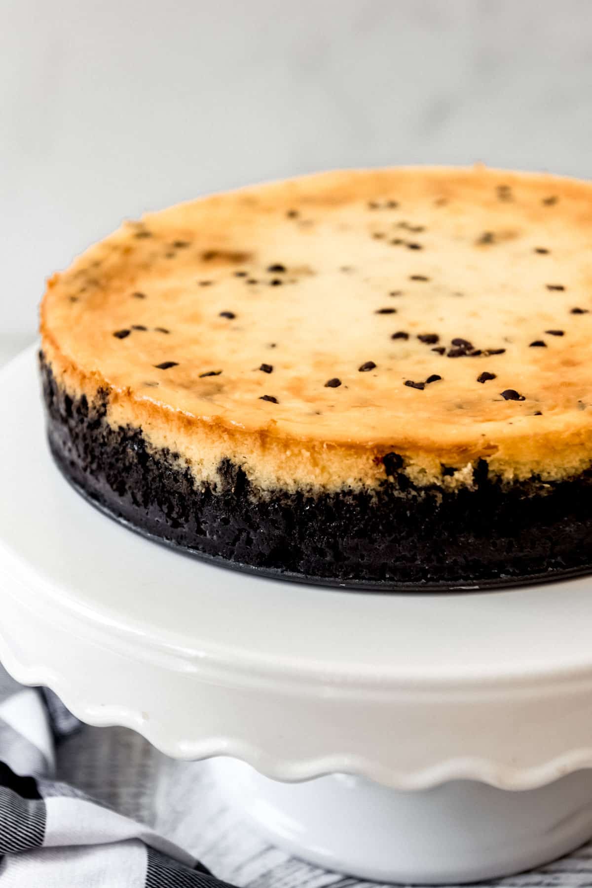 A side view of the chocolate chip cookie dough cheesecake, showing the Oreo cookie crust. 