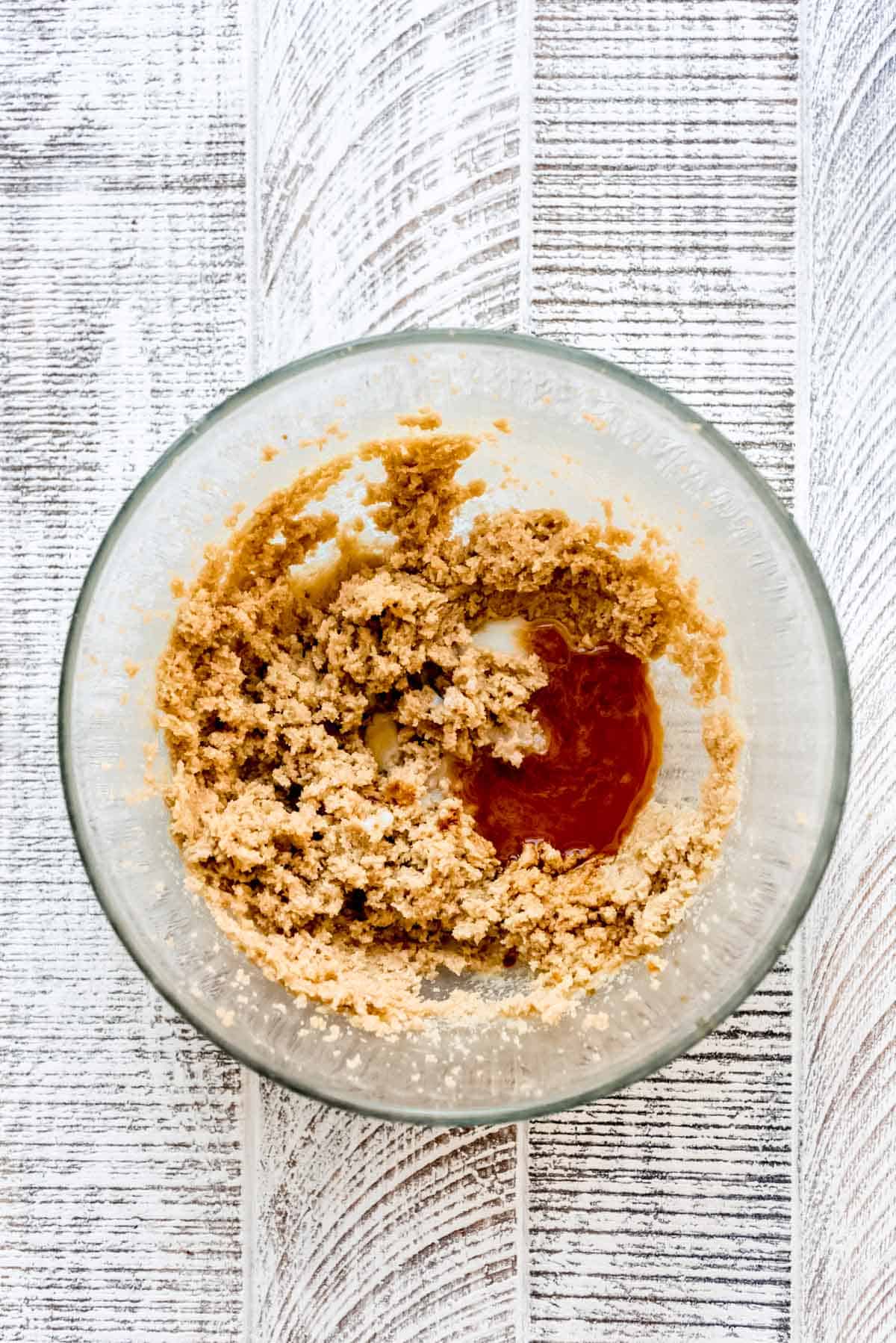 A bowl of blended sugars and butter, plus vanilla. 