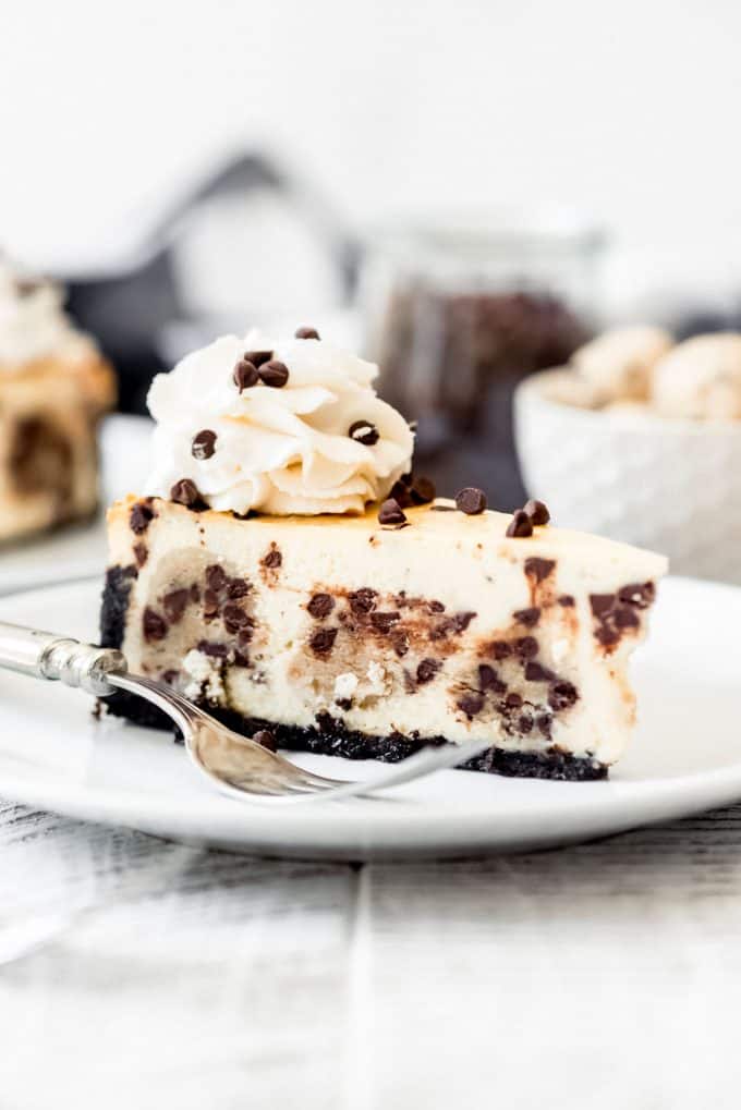 a slice of cheesecake with balls of cookie dough baked into it