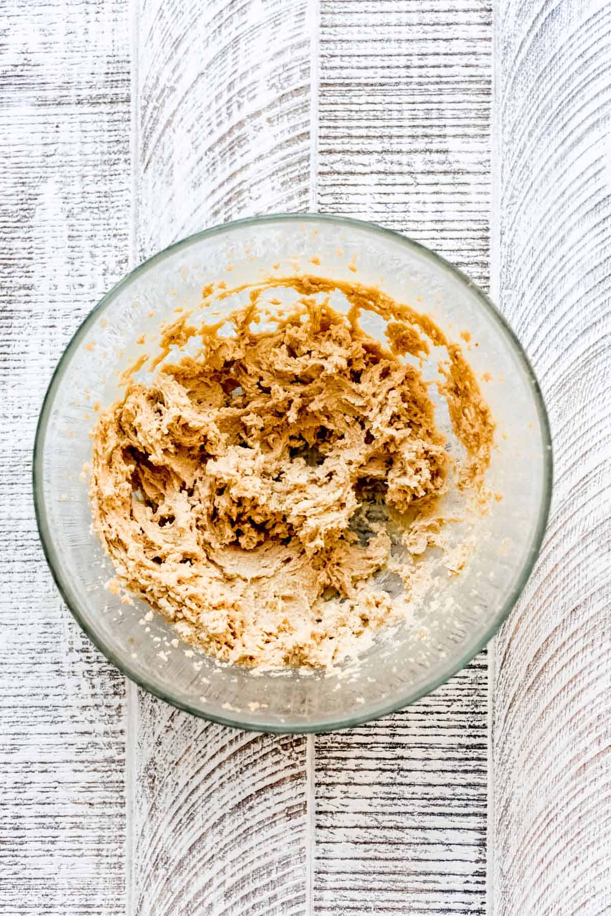 Cookie dough blended in a clear glass bowl. 