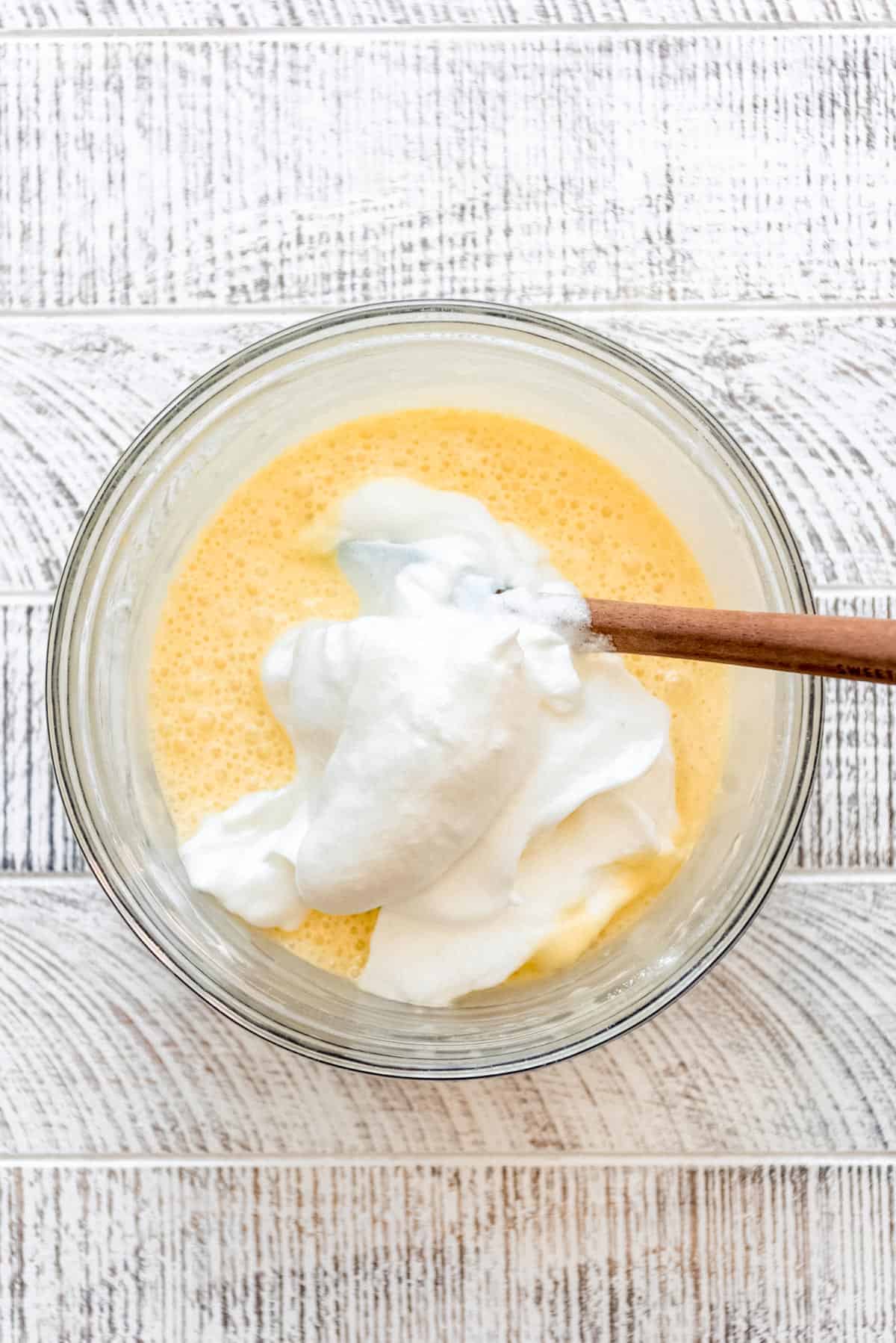 Adding some of the egg whites into the pancake batter. 