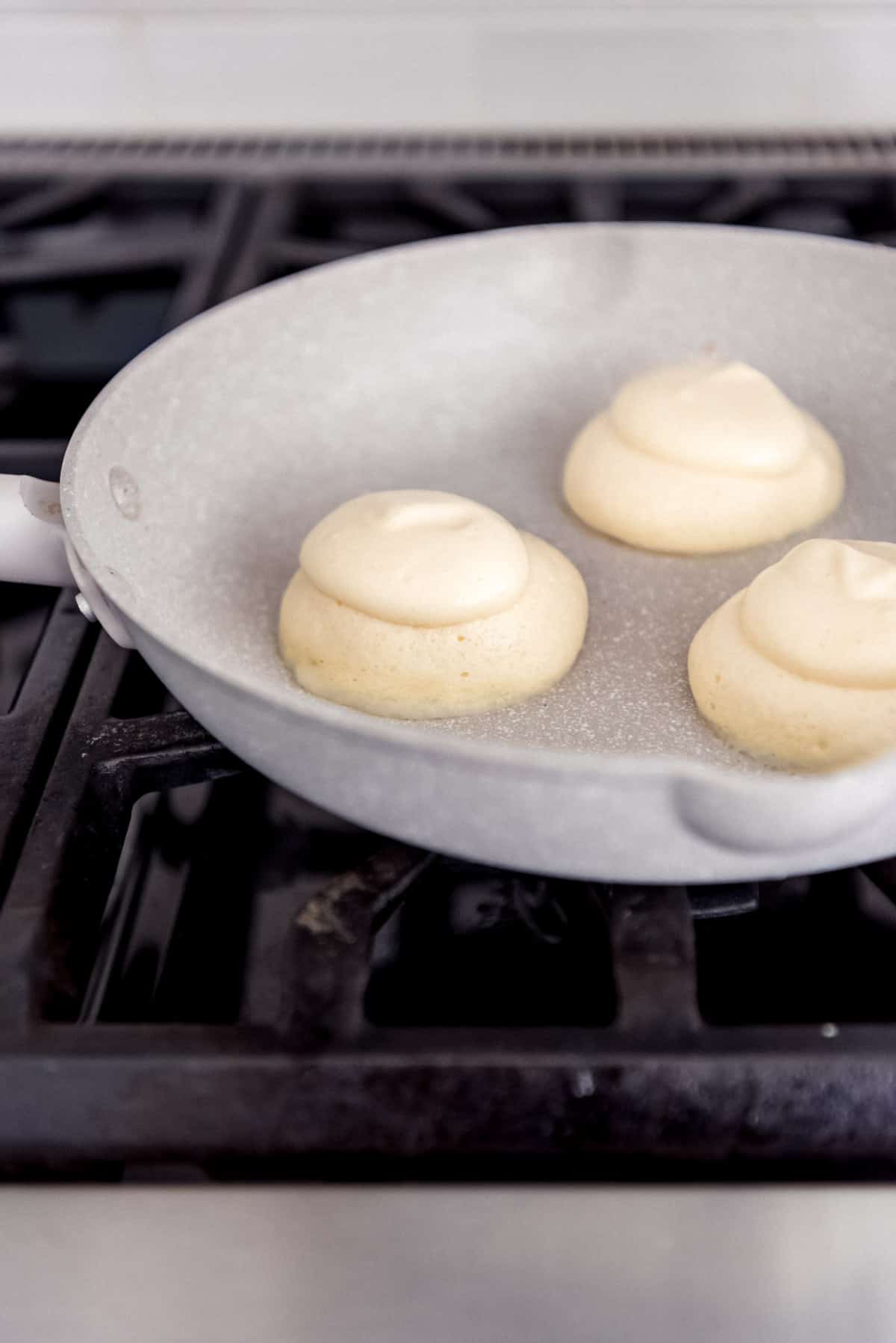 japanese pancake batter cooking on a skillet