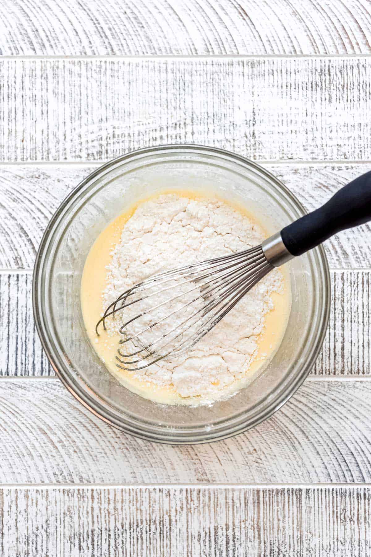 Flour and baking powder are added to the Japanese pancake batter. 