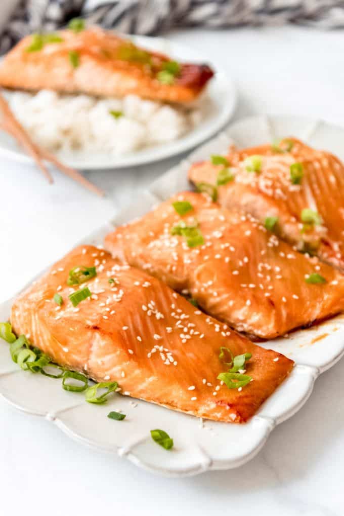 Japanese miso salmon on a plate garnished with green onions and sesame seeds
