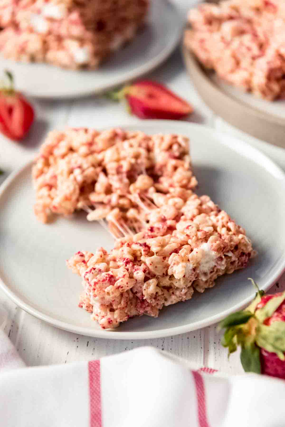 A pulled apart strawberry rice krispies treat on a plate.