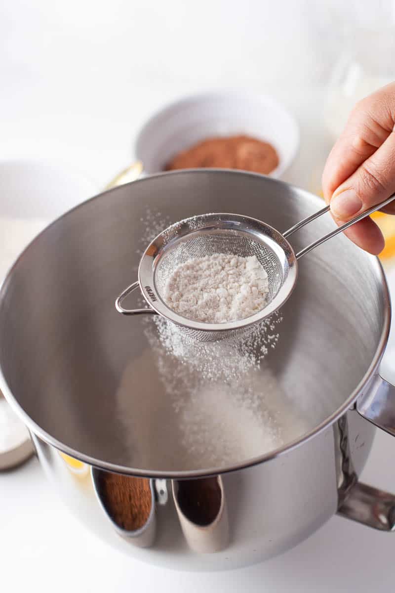 Sifting flour into a large bowl. 