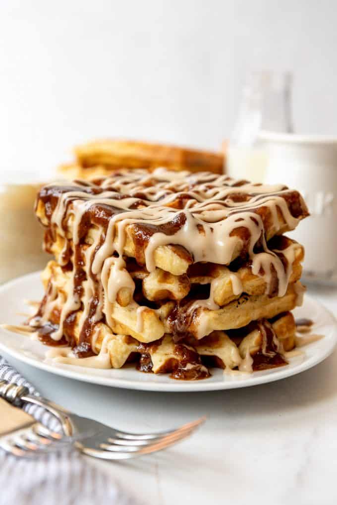 a stack of cinnamon roll waffles on a white plate