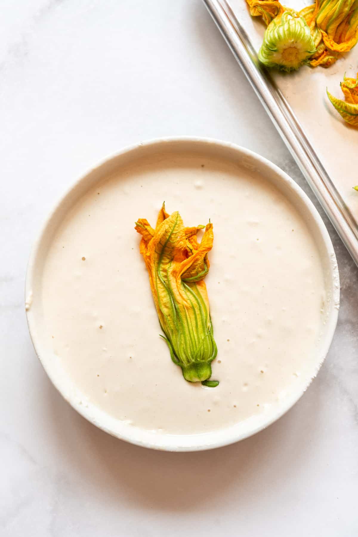 A stuffed squash blossom in a thin tempura batter.