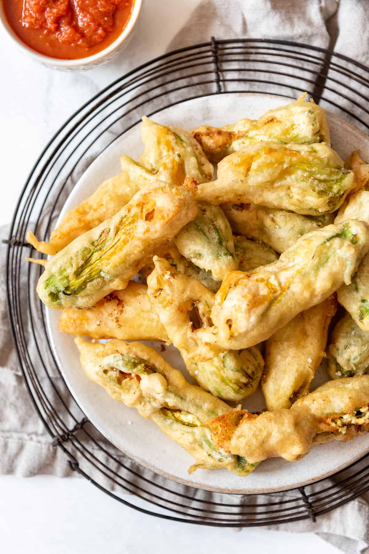 An overhead image of fried squash blossoms on a plate.