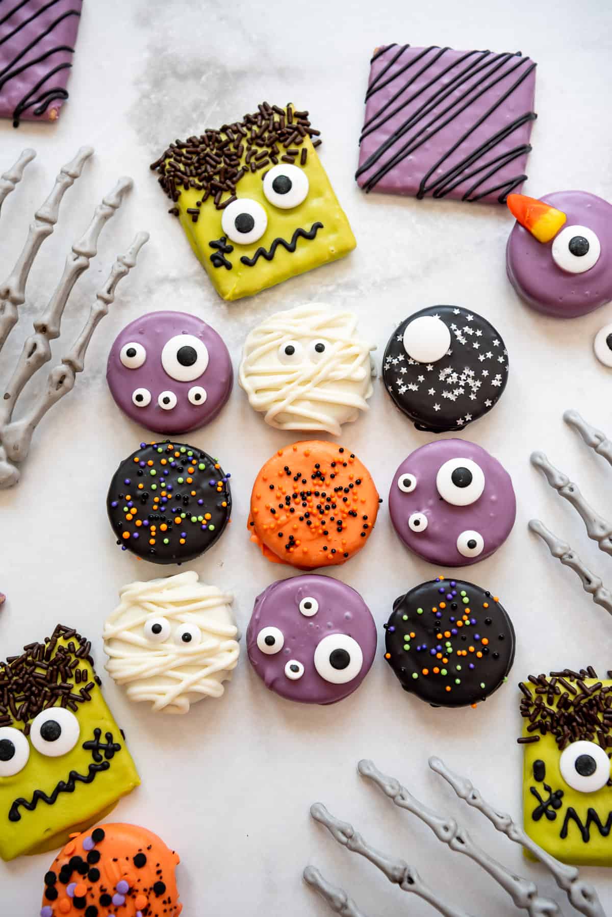Halloween chocolate covered Oreos and graham crackers decorated with sprinkles.