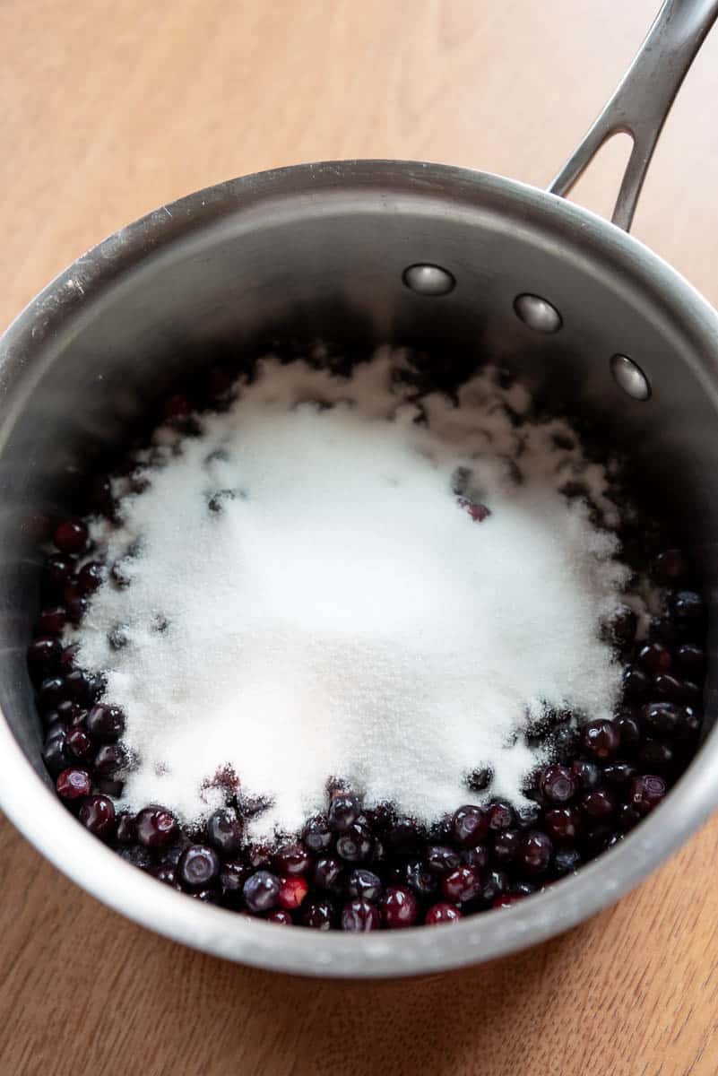 sugar and huckleberries in a saucepan