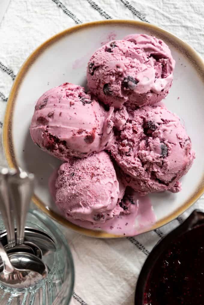 four scoops of homemade huckleberry ice cream on a plate