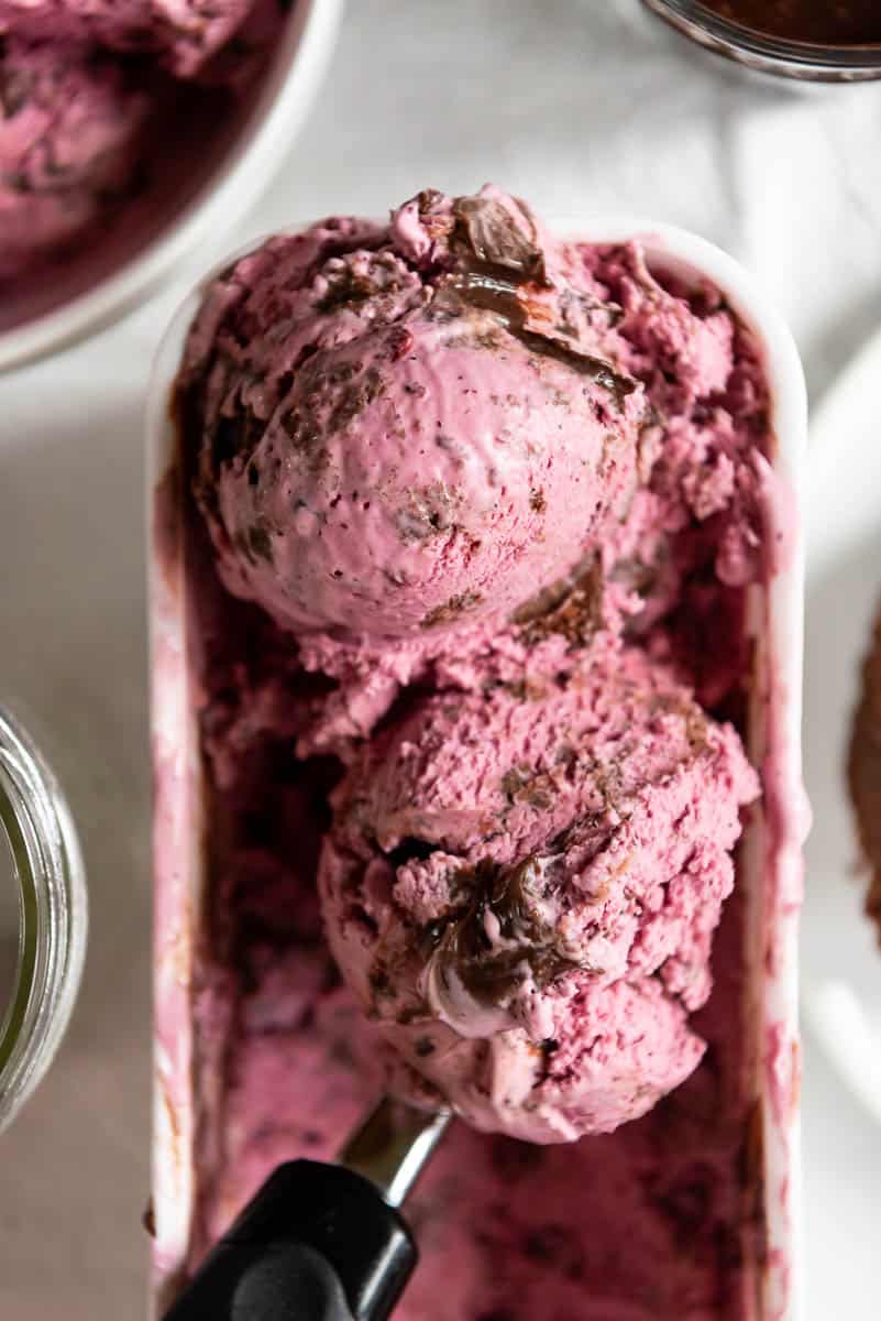 two scoops of huckleberry ice cream with brownie chunks and hot fudge swirls