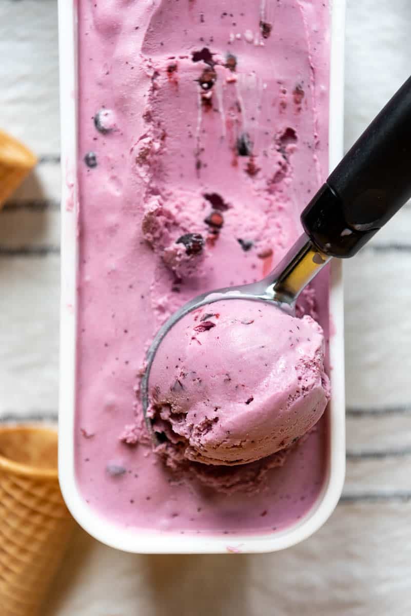 an ice cream scoop scooping huckleberry ice cream