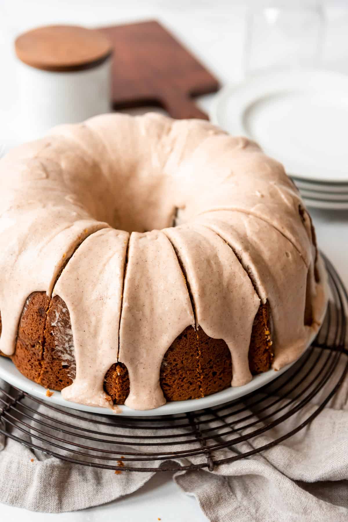 A cinnamon glaze is poured on top of a pumpkin bundt cake, and the cake has been cut into individual servings. 