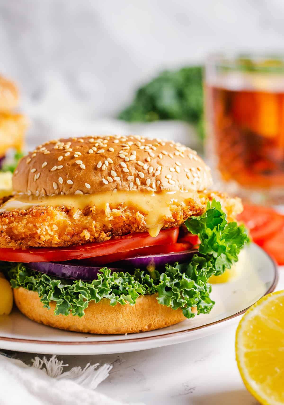 Honey mustard sauce dripping off a homemade crispy buttermilk chicken sandwich.