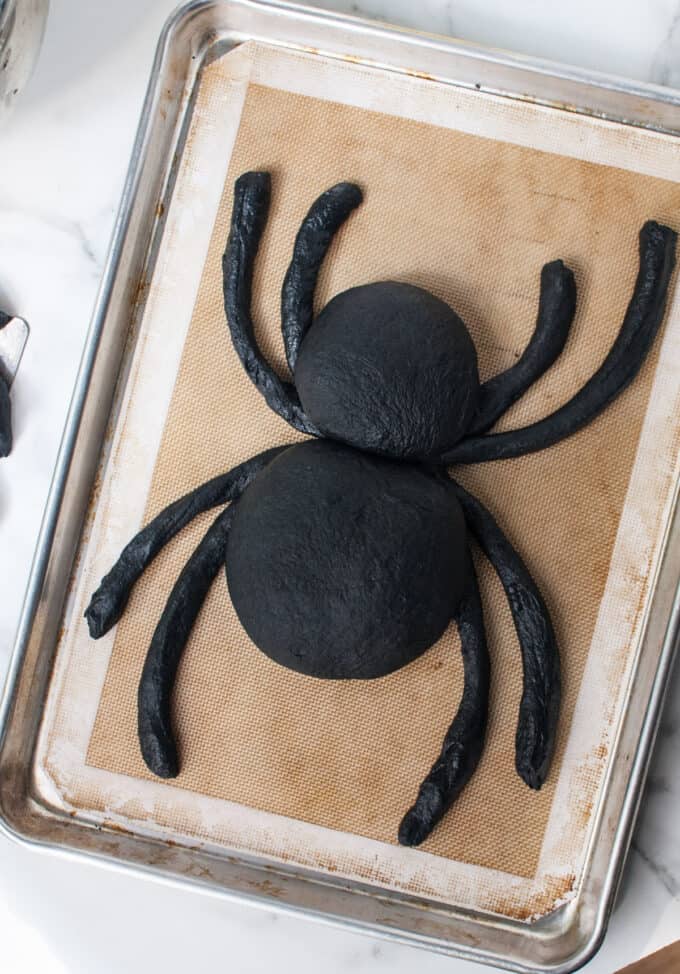 A spider bread bowl with the head attached to the abdomen.