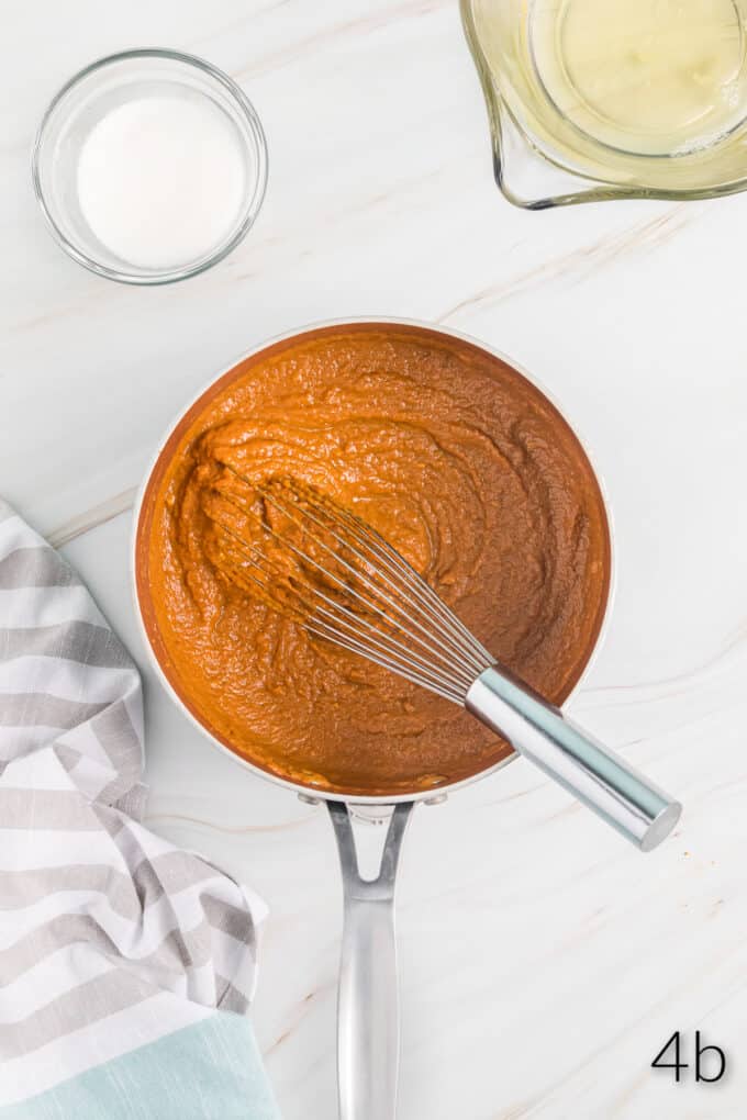 Top view of a pan with a pumpkin pie filling mix and a whisk in it.