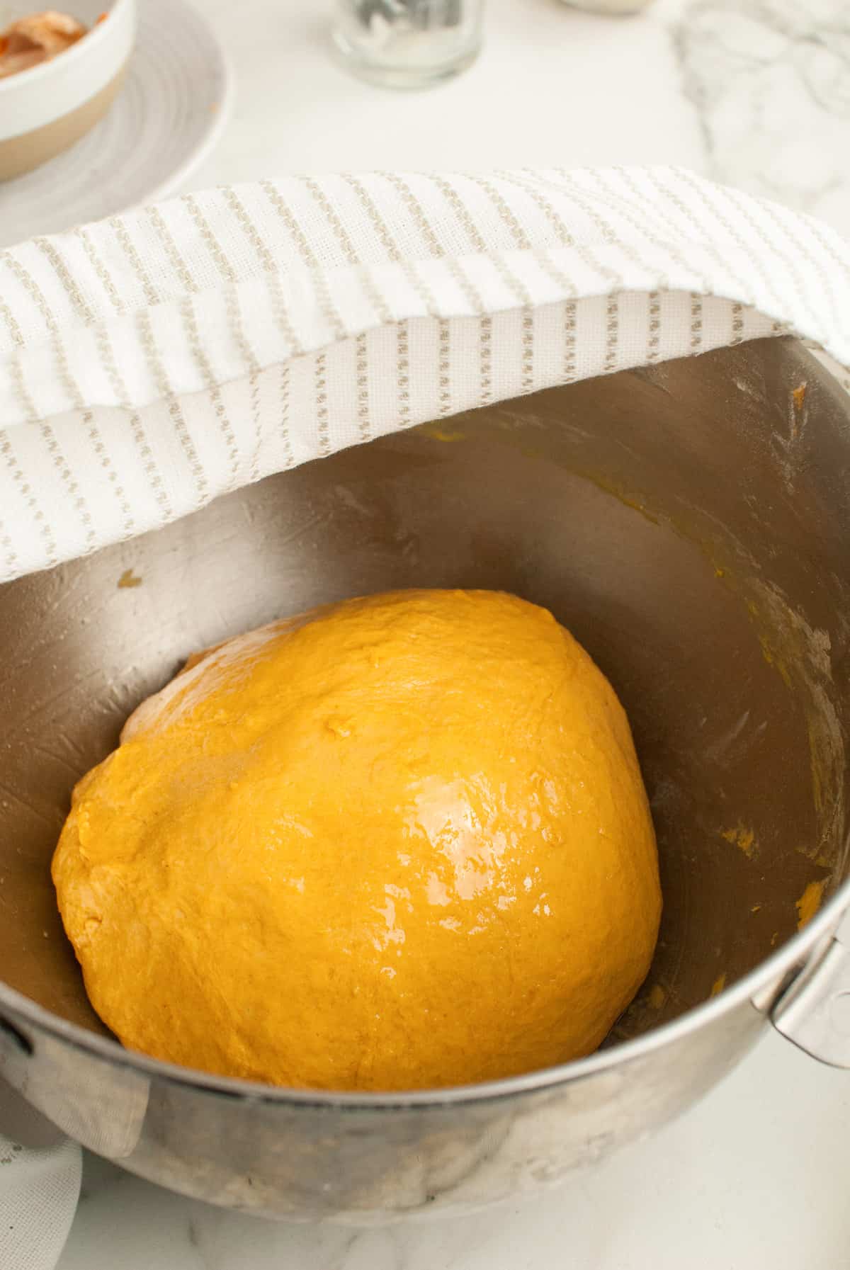 A formed ball of pumpkin roll dough. 