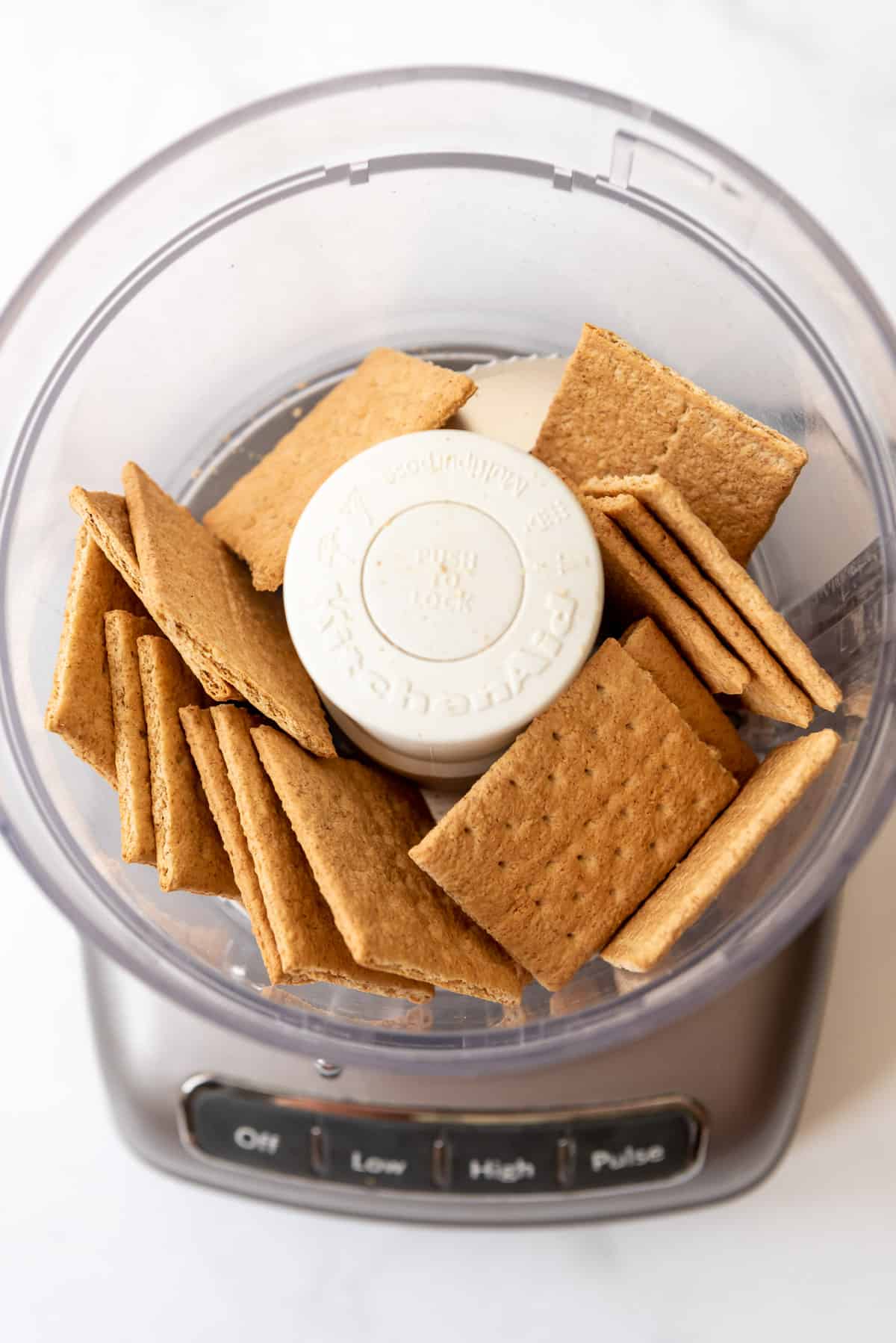 Graham crackers in a food processor, ready to be crushed. 