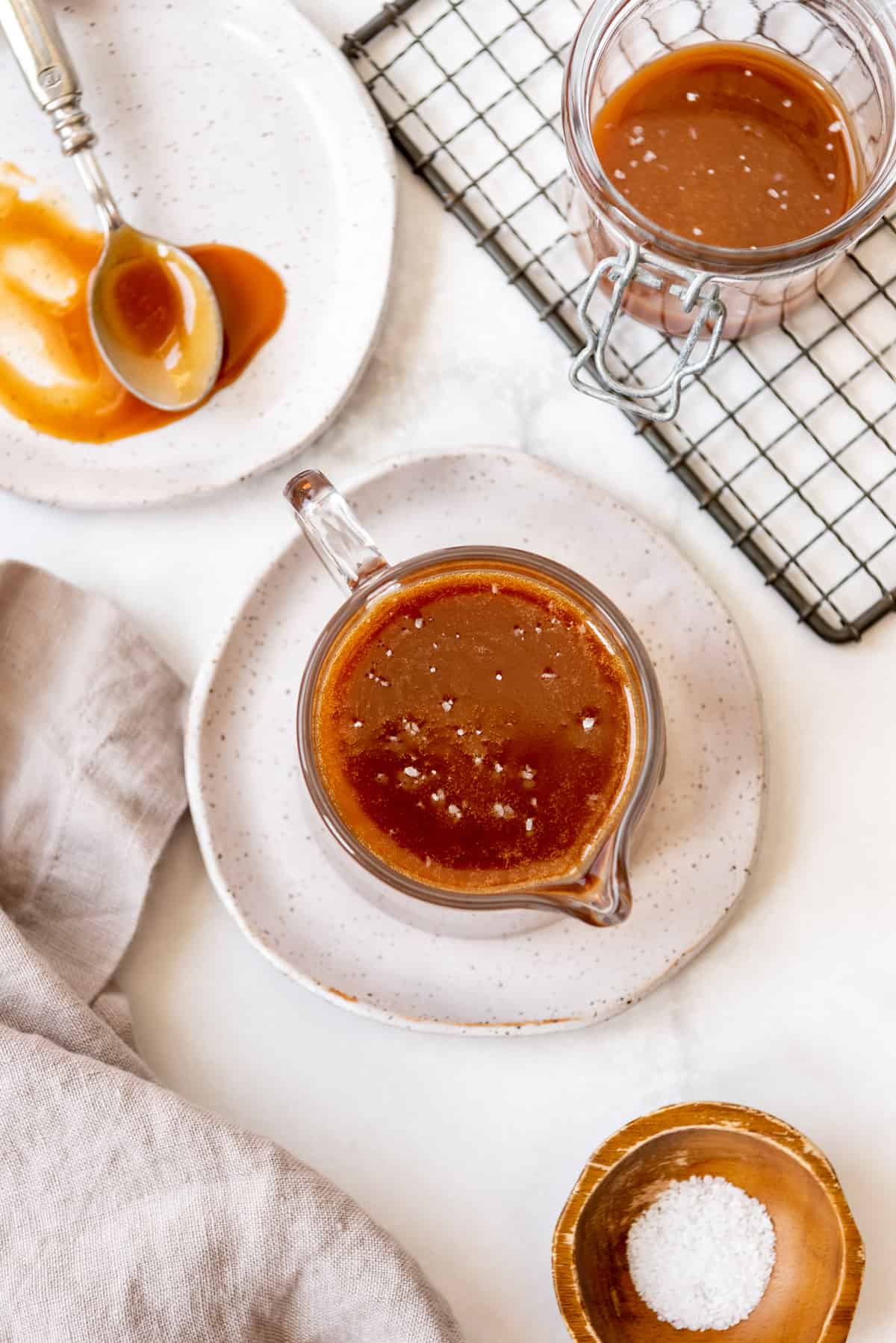 an overhead image of caramel sauce with coarse salt sprinkled on it.