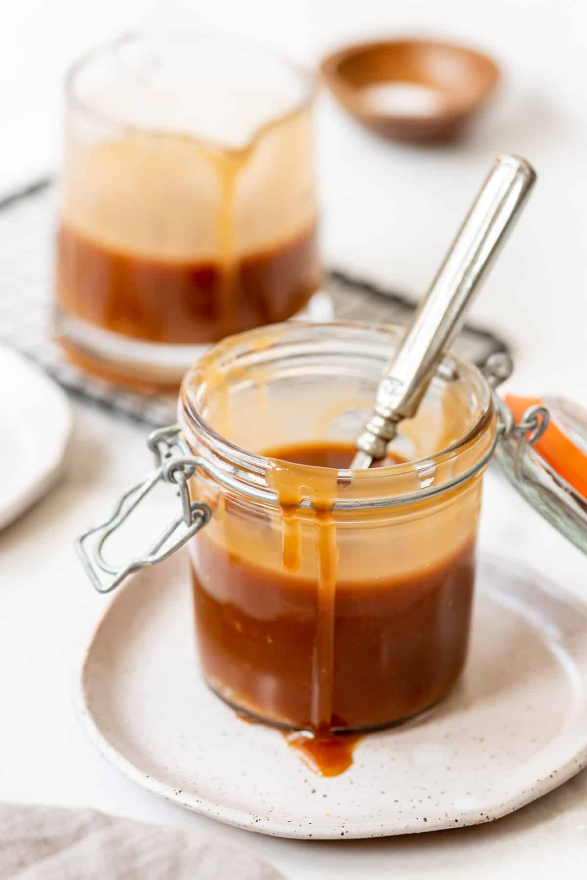 caramel sauce dripping over the side of a glass jar.