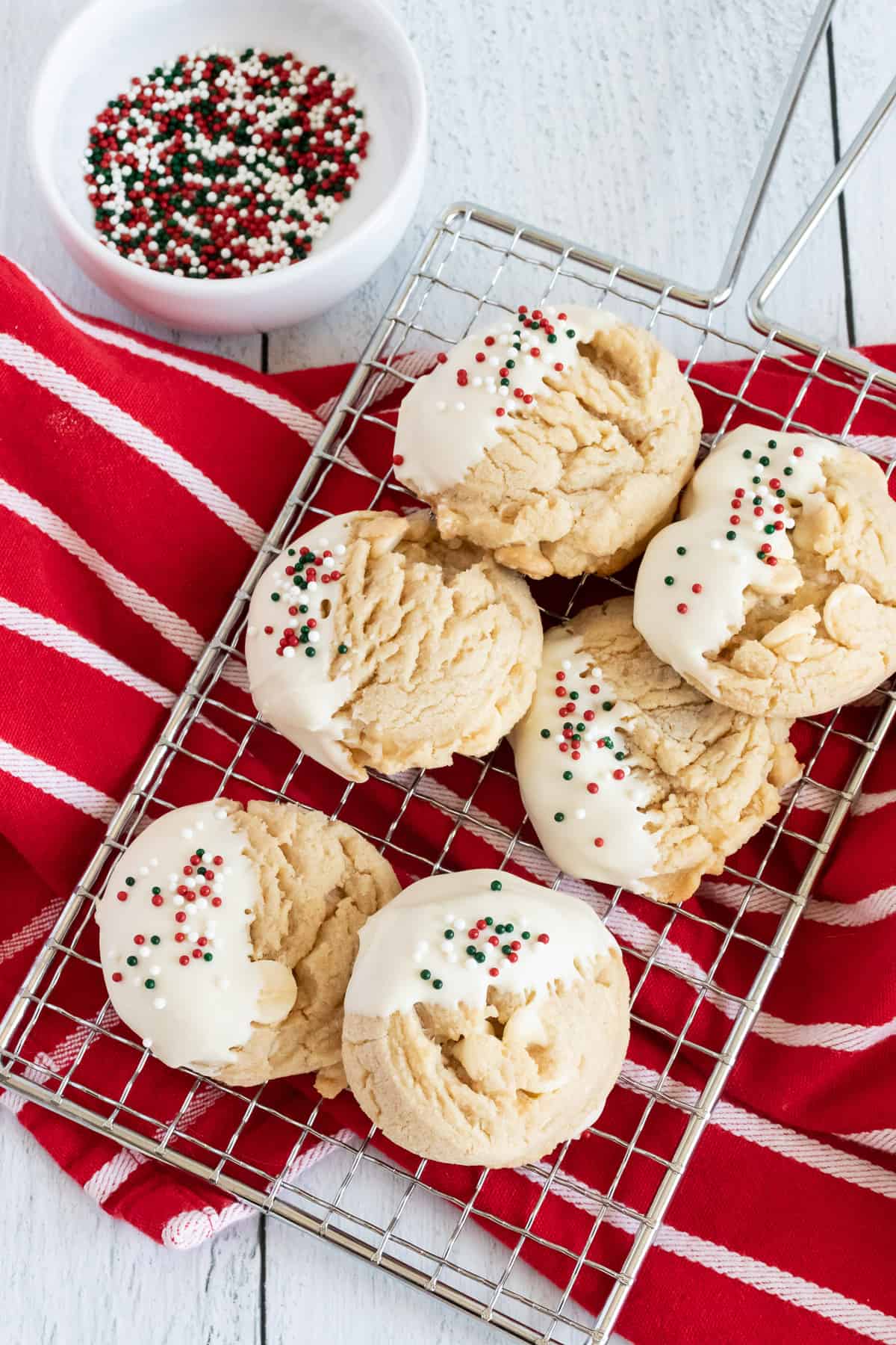 White Chocolate Peanut Butter Cookies on a cooling rack on a red dish towel