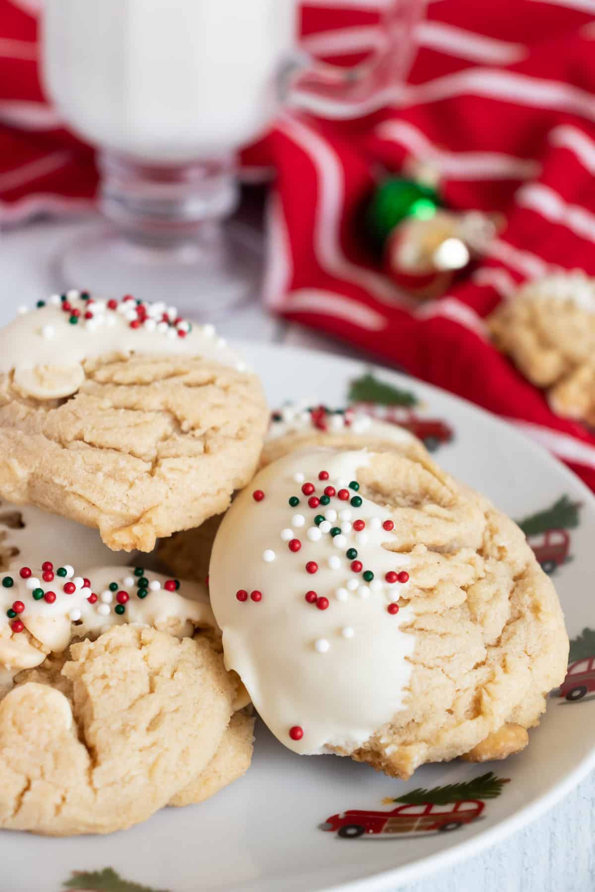 White Chocolate peanut butter cookies dipped in white chocolate with holiday sprinkles