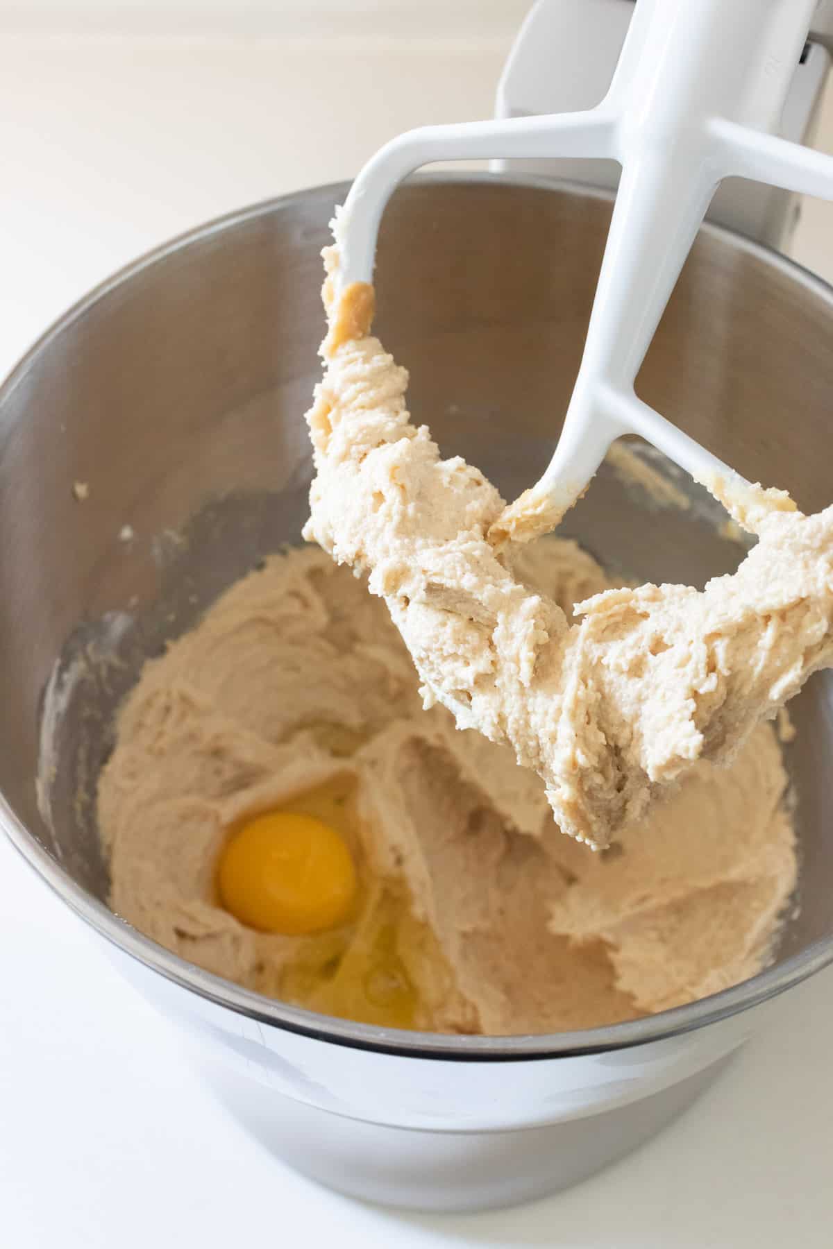 Adding an egg to the peanut butter dough. 