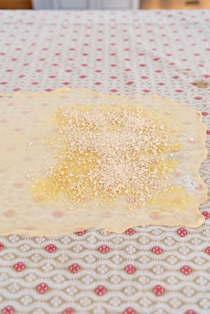 melted butter spread on thin pastry dough and sprinkled with bread crumbs.